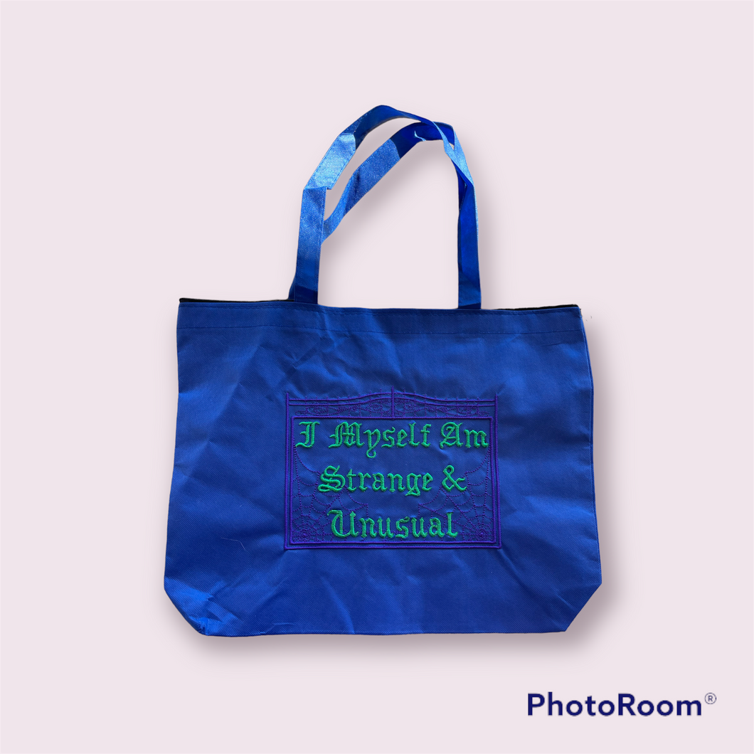 Strange and unusual on blue tote bag