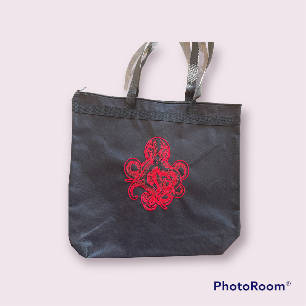 Red kraken on black tote bag