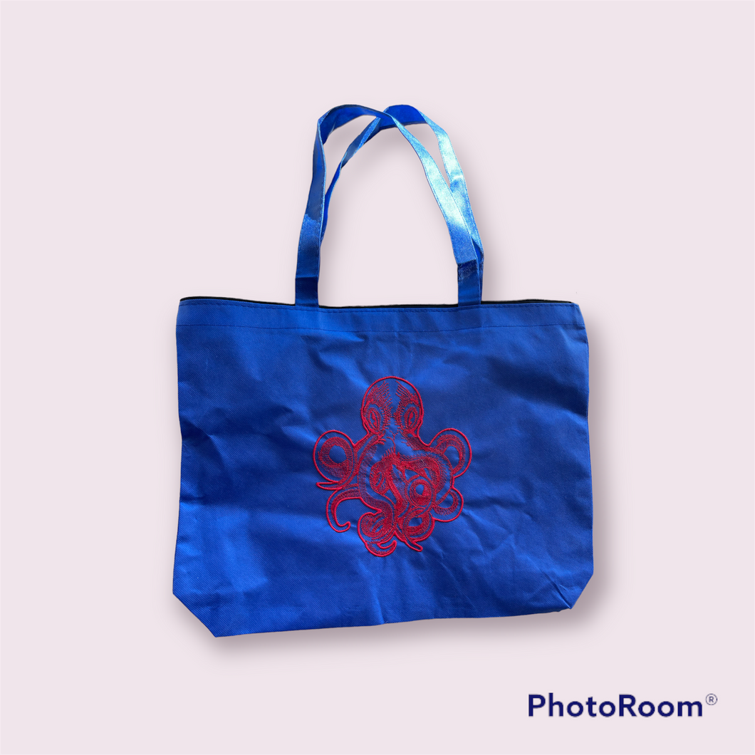 Red kraken on blue tote bag