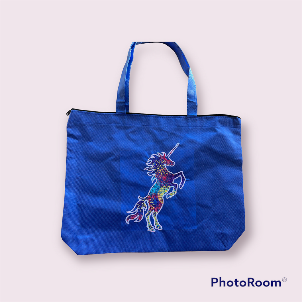 Spiral unicorn on blue tote bag