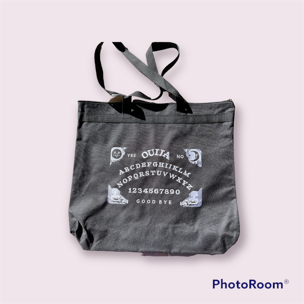 White ouiji board on black tote bag